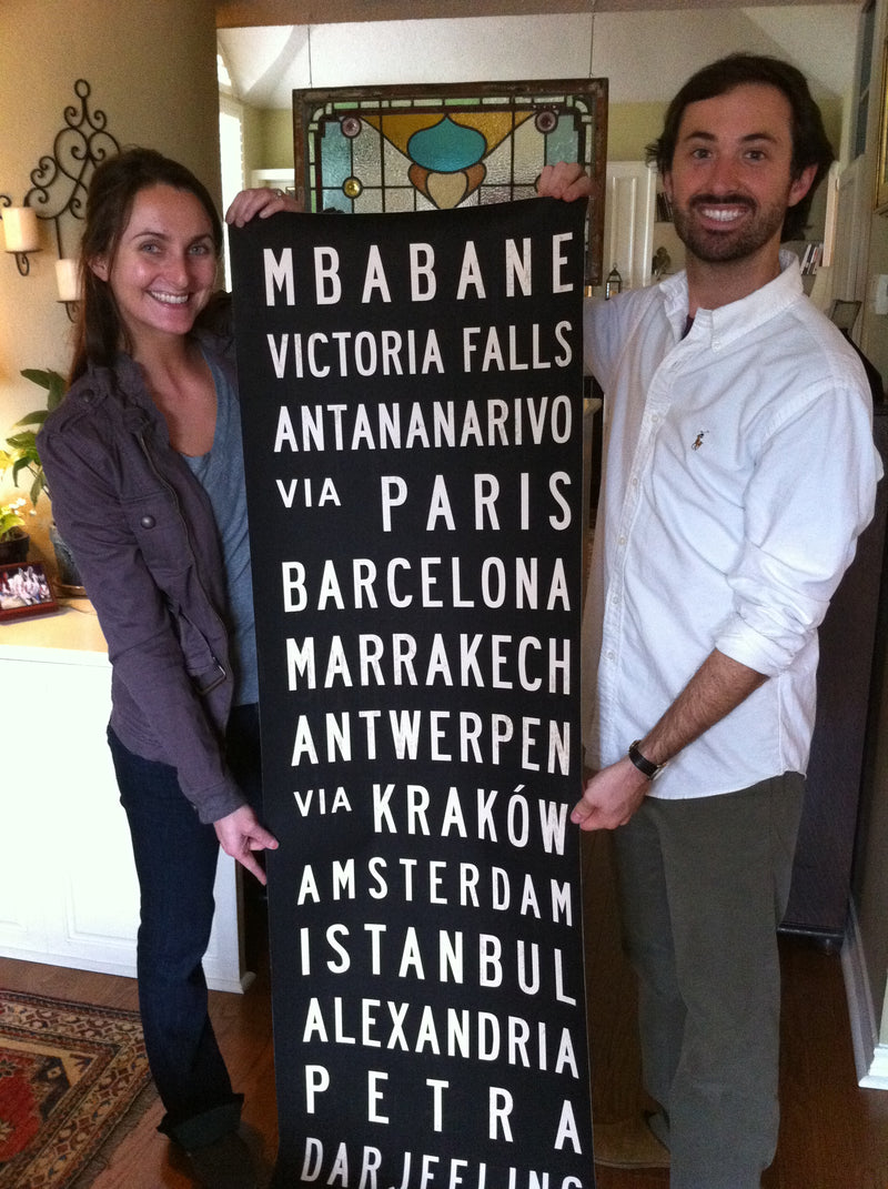 Happy Transit Design customers holding a custom subway sign.
