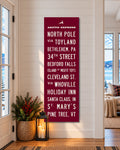 Christmas Subway Wall Art hanging in a cozy entryway