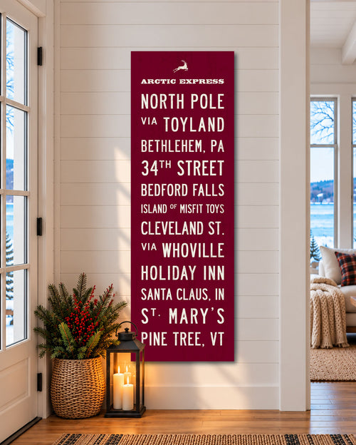 Christmas Subway Wall Art hanging in a cozy entryway