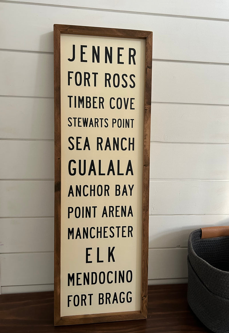 Custom Wooden subway sign with text on a white wall by Transit Design.
