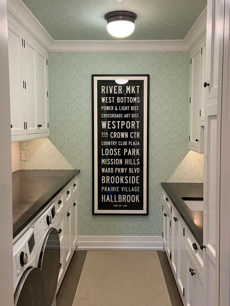Custom Subway Sign hanging in laundry room by Transit Design