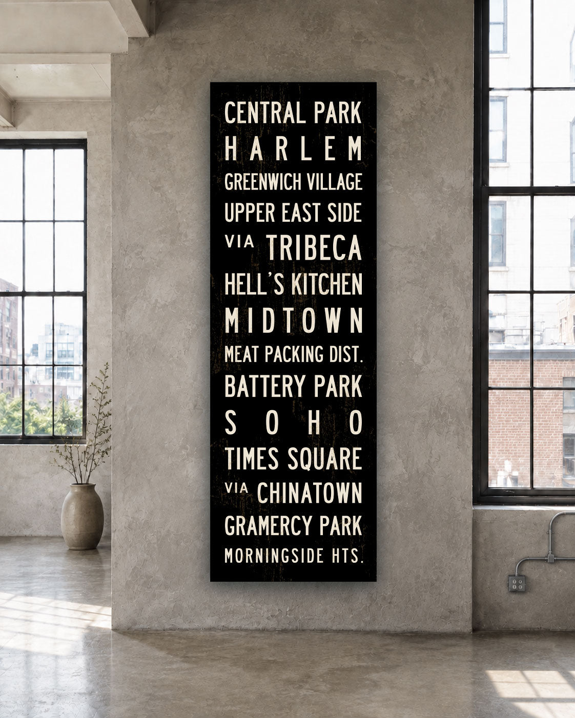 New York Subway Sign Art on stretched canvas hanging on wall in a loft