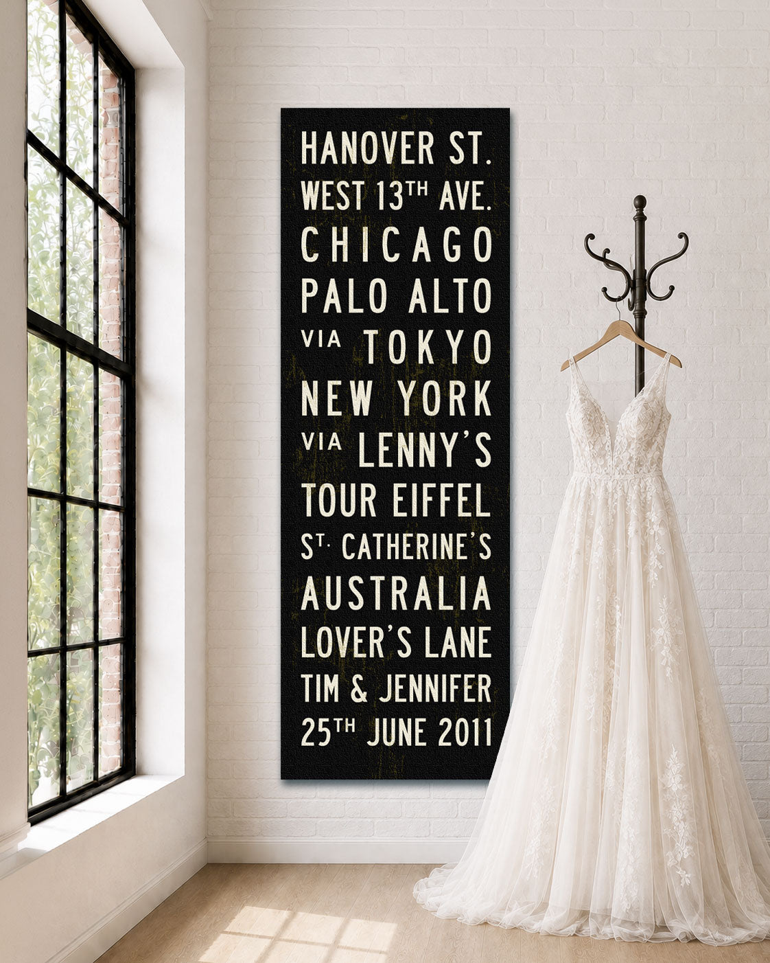 Personalized Wedding Subway Sign hanging on a wall with wedding dress on hanger next to it.