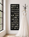 Personalized Wedding Subway Sign hanging on a wall with wedding dress on hanger next to it.