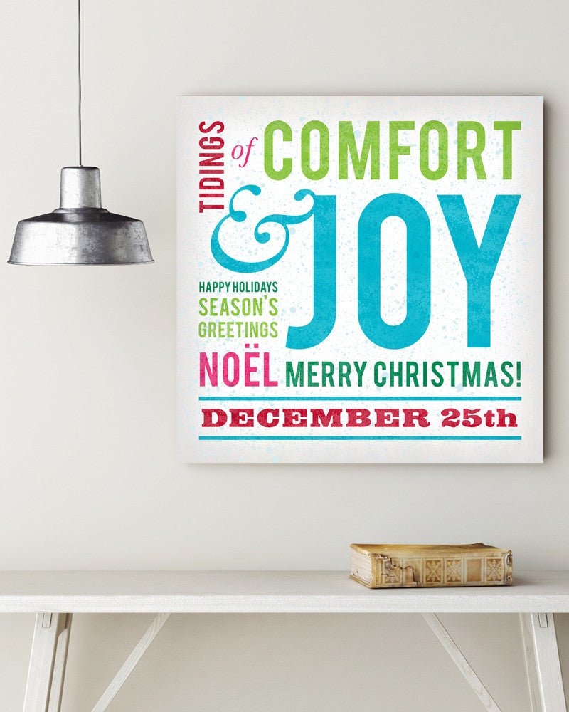 Multi-colored Comfort & Joy Christmas Wall Decor in stretched canvas hanging on a wall - Transit Design